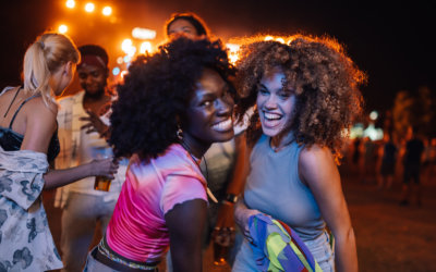Two young women smiling and having fun at a music festival
