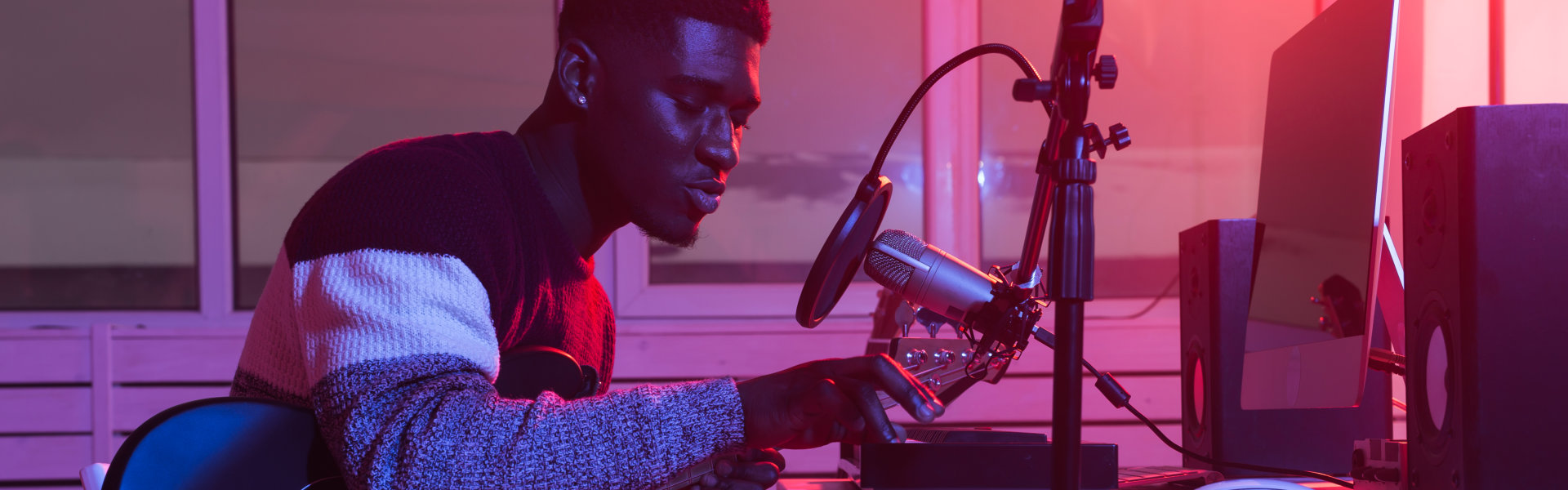 man playing music at a studio